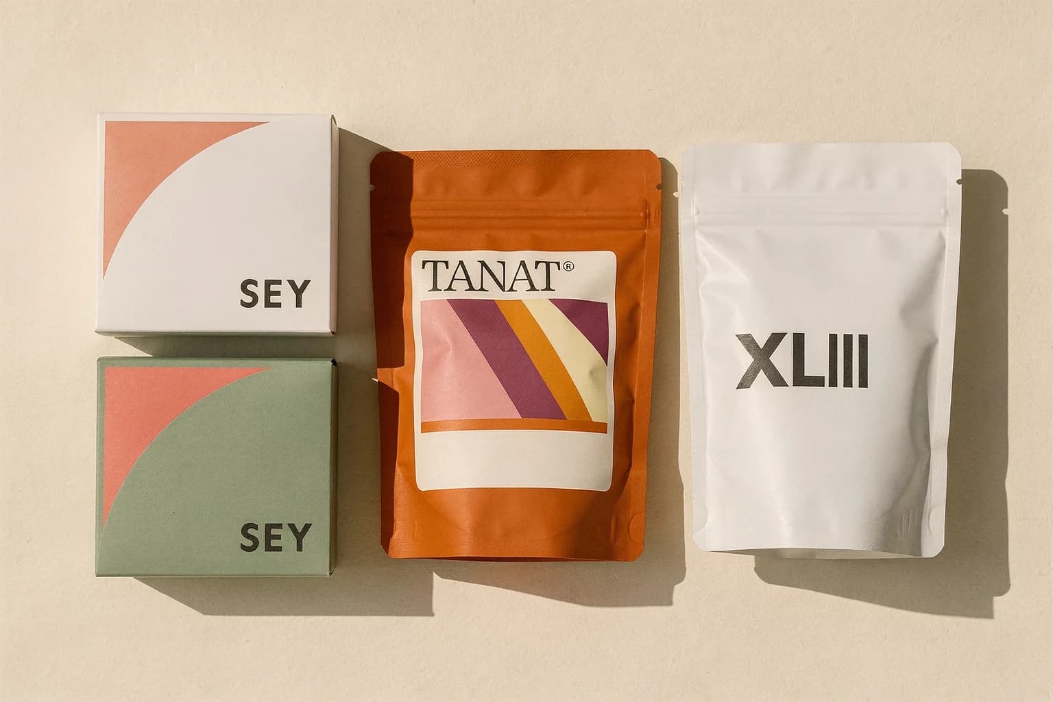 Packaging illustration: two Sey boxes, an orange Tanat bag and a white XLIII bag, with coffee-specific labels omitted